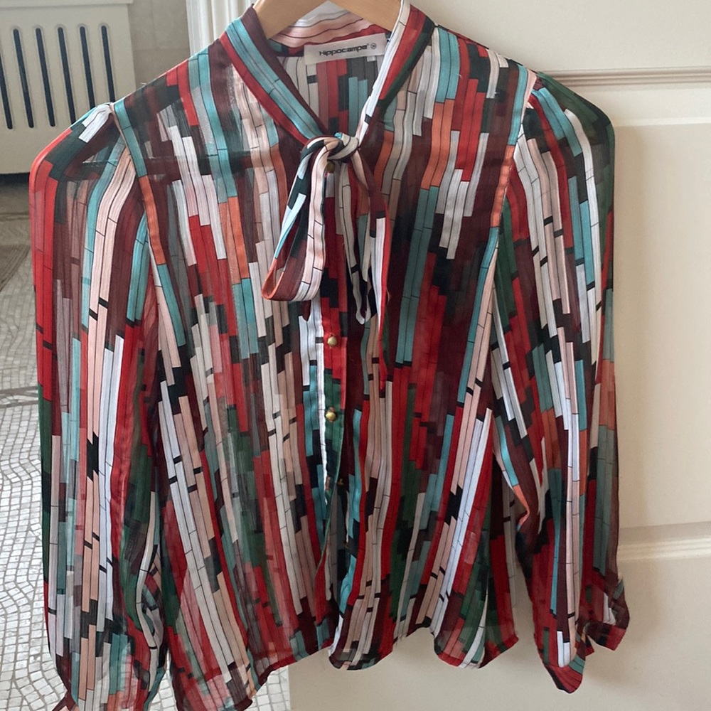 Sheer colored shirt with a tie bow and gold buttons